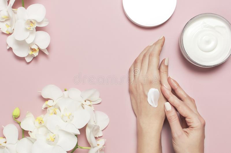 young-woman-moisturizes-her-hand-cosmetic-cream-lotion-opened-container-cream-body-milk-white-phalaenopsis-orchid-141944881